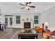 Bright living room featuring a fireplace, hardwood floors, and French doors leading to the outside at 413 Solace Pl, Canton, GA 30114