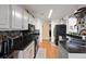 Modern kitchen with black countertops and white cabinets at 1809 Francon Sw Ct, Conyers, GA 30094