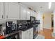 Clean kitchen with white cabinets, black countertops, and hexagon tile at 1809 Francon Sw Ct, Conyers, GA 30094