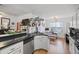 Open concept kitchen with island and dark countertops at 1809 Francon Sw Ct, Conyers, GA 30094