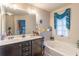 Elegant bathroom with double vanity and relaxing bathtub at 2354 Attewood Dr, Buford, GA 30519