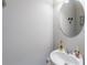 Simple bathroom with a vanity and a large circular mirror at 2354 Attewood Dr, Buford, GA 30519