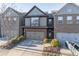 Two-story townhome with stone and siding exterior, two-car garage, and landscaping at 2354 Attewood Dr, Buford, GA 30519