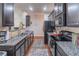 Open concept kitchen with granite countertops and dark cabinetry at 2354 Attewood Dr, Buford, GA 30519