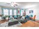 Open living and dining area with hardwood floors, sectional sofa, and fireplace at 2354 Attewood Dr, Buford, GA 30519