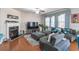 Open living area with hardwood floors, sectional sofa, fireplace, and large TV at 2354 Attewood Dr, Buford, GA 30519