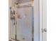 Clean shower with glass enclosure and storage shelf at 2354 Attewood Dr, Buford, GA 30519