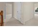 Neutral-toned hallway with carpet flooring showing doorways to various rooms of the home at 5480 Beaver Ridge Dr, Cumming, GA 30040