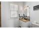 Clean bathroom with granite vanity, updated fixtures, and a window at 1055 Leadenhall St, Alpharetta, GA 30022
