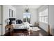 Main bedroom with a king-size bed, dark hardwood floors, and a sitting area at 1055 Leadenhall St, Alpharetta, GA 30022