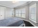 Bright bedroom with large windows, gray walls, and plush bedding at 1055 Leadenhall St, Alpharetta, GA 30022