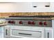 High-end stainless steel cooktop with red knobs at 1055 Leadenhall St, Alpharetta, GA 30022
