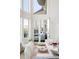 Bright dining room with white chairs and table, access to a private balcony at 1055 Leadenhall St, Alpharetta, GA 30022