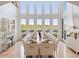 Formal dining room with long table, white chairs, and large windows offering scenic views at 1055 Leadenhall St, Alpharetta, GA 30022