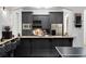 Basement bar with granite countertop, dark cabinetry, and modern appliances at 1055 Leadenhall St, Alpharetta, GA 30022