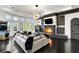 Game room with stone fireplace, large sectional sofa, and dark hardwood floors at 1055 Leadenhall St, Alpharetta, GA 30022