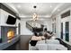 Game room with stone fireplace, sectional sofa, and access to other rooms at 1055 Leadenhall St, Alpharetta, GA 30022