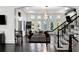 Spacious game room with arcade game, seating area, and hardwood floors at 1055 Leadenhall St, Alpharetta, GA 30022