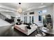 Game room with sectional sofa, arcade game, and hardwood floors at 1055 Leadenhall St, Alpharetta, GA 30022