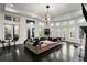 Game room with sectional sofa, large windows, and hardwood floors at 1055 Leadenhall St, Alpharetta, GA 30022