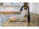 Modern kitchen sink and faucet fixture in a granite countertop at 1055 Leadenhall St, Alpharetta, GA 30022