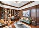 Luxurious library with built-in bookshelves, hardwood floors, and a cozy seating area at 1055 Leadenhall St, Alpharetta, GA 30022