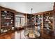 Bright library with hardwood floors, custom bookshelves, and a circular staircase at 1055 Leadenhall St, Alpharetta, GA 30022