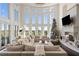 Two story living room with large windows, fireplace, and sectional sofa at 1055 Leadenhall St, Alpharetta, GA 30022