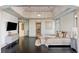 Spacious main bedroom with dark hardwood floors, large TV, and luxurious bedding at 1055 Leadenhall St, Alpharetta, GA 30022
