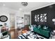 Stylish office with hardwood floors, green velvet sofa, and statement art at 1055 Leadenhall St, Alpharetta, GA 30022