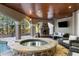 Covered patio with fireplace, hot tub, and pool at 1055 Leadenhall St, Alpharetta, GA 30022