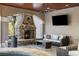 Covered patio with fireplace, wicker furniture, and TV at 1055 Leadenhall St, Alpharetta, GA 30022
