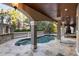 Inviting freeform pool with stone patio and covered area at 1055 Leadenhall St, Alpharetta, GA 30022