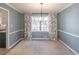 Dining room with hardwood floors, light blue walls, and a chandelier at 296 Ridgedale Way, Lawrenceville, GA 30044