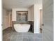 Elegant bathroom with soaking tub, walk-in shower, and gray tile floors at 301 Delta Dr, Mcdonough, GA 30252