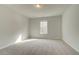 Bright bedroom with neutral walls and carpet at 301 Delta Dr, Mcdonough, GA 30252