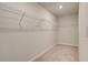 Spacious walk-in closet with wire shelving and neutral carpeting at 301 Delta Dr, Mcdonough, GA 30252