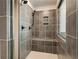 Large walk-in shower with gray tile, built-in seat, and window at 301 Delta Dr, Mcdonough, GA 30252