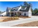 Two story farmhouse with metal roof, attached three-car garage, and landscaping at 39 Telfair Ct, Acworth, GA 30101