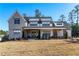 Two-story farmhouse with metal roof, large porch, and landscaping at 39 Telfair Ct, Acworth, GA 30101