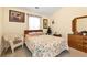 Bedroom with floral bedding, wicker chair, and wood dresser at 1967 Woodland Park Cir, Lawrenceville, GA 30043