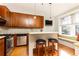 Modern kitchen with wood cabinets, granite counters, and island at 266 11Th Ne St # 308, Atlanta, GA 30309