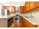 Modern kitchen with wood cabinets and granite counters at 266 11Th Ne St # 308, Atlanta, GA 30309