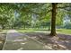 Paved pathway winds through a lush park with mature trees and expansive green lawns at 266 11Th Ne St # 308, Atlanta, GA 30309