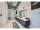 Elegant Primary bathroom with a double vanity, large mirror, and marble floors at 2015 Shaudi Ln, Atlanta, GA 30345