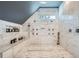 Luxurious Primary bath boasts a spacious marble shower with multiple shower heads and a built-in bench at 2015 Shaudi Ln, Atlanta, GA 30345