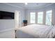 Large primary bedroom featuring carpeting, a ceiling fan, and an attached bathroom at 2015 Shaudi Ln, Atlanta, GA 30345