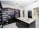 Walk-in closet with central island, black cabinets, and shelving for storage at 2015 Shaudi Ln, Atlanta, GA 30345