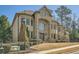 Beautiful stone and brick house with manicured lawn and mature trees in a suburban neighborhood at 2015 Shaudi Ln, Atlanta, GA 30345