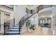 Grand foyer featuring a staircase with black iron railings, light hardwood floors, and high ceilings at 2015 Shaudi Ln, Atlanta, GA 30345